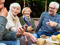 Friends laughing and talking while enjoying the outdoors