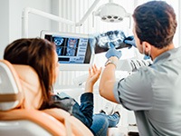 Dentist and patient reviewing X-ray