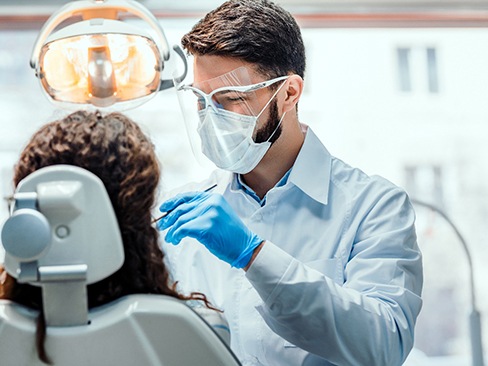 A dentist working with one of his patients