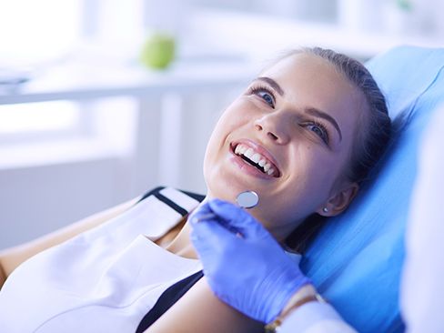 patient smiling while getting cosmetic dentistry in Dallas