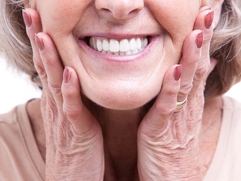 closeup of woman smiling after getting dentures in Dallas