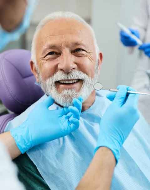 a patient smiling while getting a dental checkup