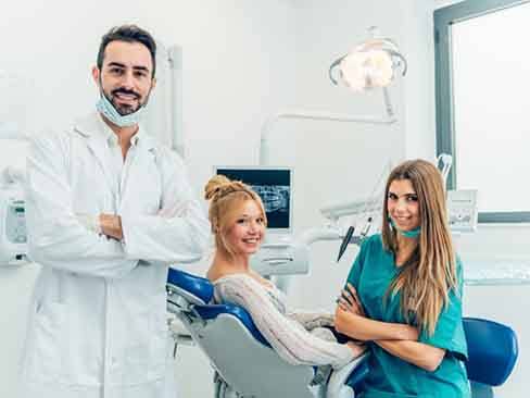 a patient and dental team smiling