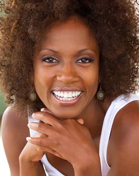 woman with dental implants in Dallas smiling brightly