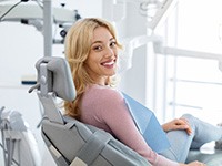 Smiling woman sitting in dentist's treatment chair