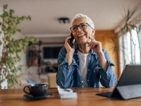 Woman smiling while talking on phone at home