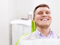 Smiling man sitting in dental office