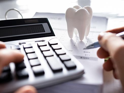 A patient calculating the cost of root canal treatment