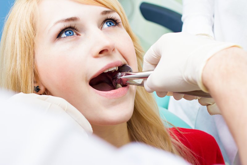 A woman undergoing a wisdom tooth extraction