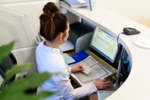 a front desk worker inputting insurance information in a computer