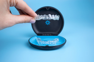 Taking an Invisalign aligner out of its case